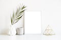 White frame and home decoration details on tabletop with wall, artwork poster mock-up Royalty Free Stock Photo