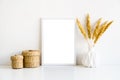 White frame and home decoration details on tabletop with wall, artwork poster mock-up Royalty Free Stock Photo