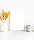 White frame and home decoration details on tabletop with wall, artwork poster mock-up Royalty Free Stock Photo