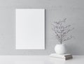 White frame mockup and home decoration on gray wall with white flower vase and books, Royalty Free Stock Photo