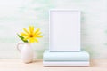 White frame mockup with bright yellow flowers and books Royalty Free Stock Photo