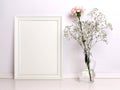 White frame mockup with flowers. Royalty Free Stock Photo