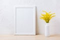 White frame mockup with ornamental yellow flowering grass in vase