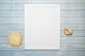 White frame and shells on a wooden turquoise background for mockup, copy space, summer sea trip concept Royalty Free Stock Photo
