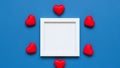 White frame surrounded by red hearts on blue background Royalty Free Stock Photo