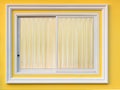 White frame window in yellow wall with curtain. Royalty Free Stock Photo