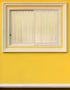 White frame window in yellow wall with curtain. Royalty Free Stock Photo