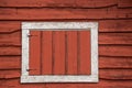 White framed hay loft door on an old red barn