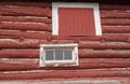 White framed hay loft door and windows on an old red barn Royalty Free Stock Photo