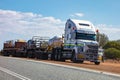 White Freightliner heavy road train truck of Centurion company transporting extremely heavy load in Western Australia Royalty Free Stock Photo