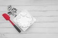 White fresh cream cake frosting with baking accessories utensils on table, flat lay one white background