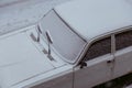 The White fresh snow on a dirty wet car outdoor in winter Royalty Free Stock Photo