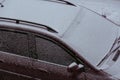 The White fresh snow on a dirty wet car outdoor in winter Royalty Free Stock Photo