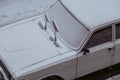 The White fresh snow on a dirty wet car outdoor in winter. Royalty Free Stock Photo