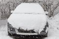 White fresh snow is on a silver dirty wet car outdoor in winter Royalty Free Stock Photo