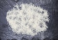 White friable crude Thai rice on a stone black background. Royalty Free Stock Photo