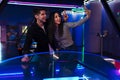 White friends taking selfie photo while playing air hockey