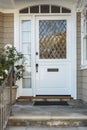 White front door of upscale beige home