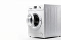 White Front Load Washing Machine Isolated on White Background. Modern Washer with Electronic Control Panel. Side View of Household Royalty Free Stock Photo