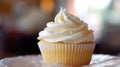 A white frosted cupcake on a white plate, AI