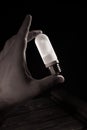 White frosted flash pilot lamp in hand. Studio photo in hard light Royalty Free Stock Photo