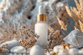 White frosted glass dropper bottle with golden cap, surrounded by stones and dried plants. Concept of natural skin care