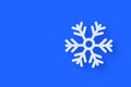 White frozen snowflake on blue background. Large snowfalls in winter