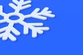 White frozen snowflake on blue background. Large snowfalls in winter