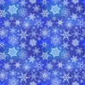 White frozen snowflakes on blue winter background, seamless pattern