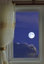 White full moon and clouds in the window view at night Royalty Free Stock Photo