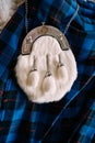 White fur sporran. A SPORRAN waist bag, a decorative piece of Scots national clothing, made of white fur with three Royalty Free Stock Photo