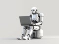 Android robot working on laptop Royalty Free Stock Photo