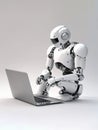 Android robot working on laptop Royalty Free Stock Photo