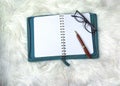 White fuzzy soft fur, purple reading glasses, and empty blank white notebook