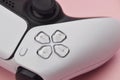 White game controller isolated on pink background. Royalty Free Stock Photo