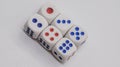 White game cubics with blue and red spikes dots on a white background. Game, gambling, chance and risk concept Royalty Free Stock Photo