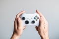 A white gamepad is in the hands of a man Royalty Free Stock Photo