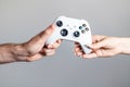 White gamepad in the hands of two people Royalty Free Stock Photo