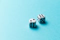 White gaming dice on blue background. Top view. Flat lay. Copy space. Game of chance concept