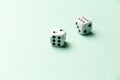 White gaming dice on mint background. Top view. Flat lay. Copy space