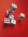 White gaming dice on a red background