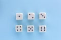 White gaming dices on light blue background. victory chance and lucky. Flat lay style, place for text. Top view and Close-up cube