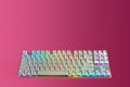 White gaming keyboard with RGB Light. Game keyboard on pink background with space for your text. The concept of gaming accessories