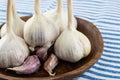 White Garlic Head And Cloves Folded In A Wooden Bowl Close-up