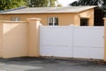 White gate large portal with blades in city suburbs house street Royalty Free Stock Photo