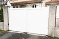 White gate large portal with double door panel blades in city suburbs house street Royalty Free Stock Photo