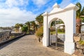White gate to luxury hotel on coastal promenade Royalty Free Stock Photo