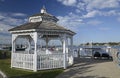 White gazebo by a harbor in the early morning