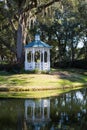 White Gazebo by Lake Under Spanish Moss