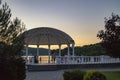 White gazebo at sunset by a mountain lake Royalty Free Stock Photo